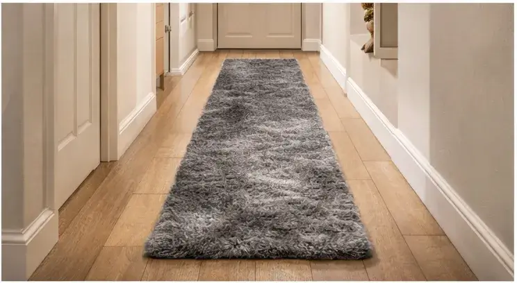 Minimal bedroom with a plush runner rug beside the bed for a premium calm look